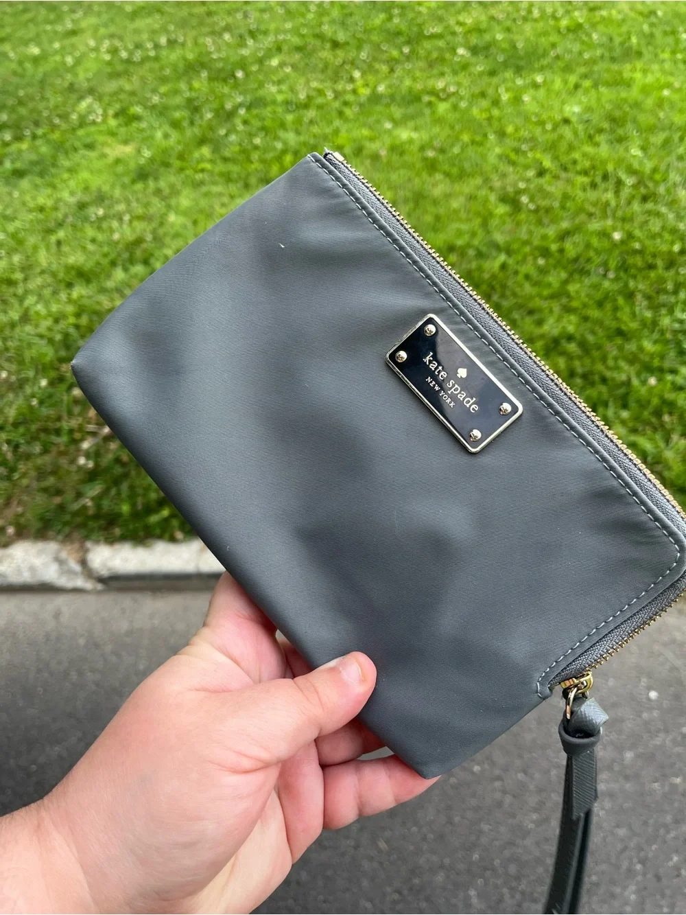 kate spade gray wristlet clutch with gold nameplate
